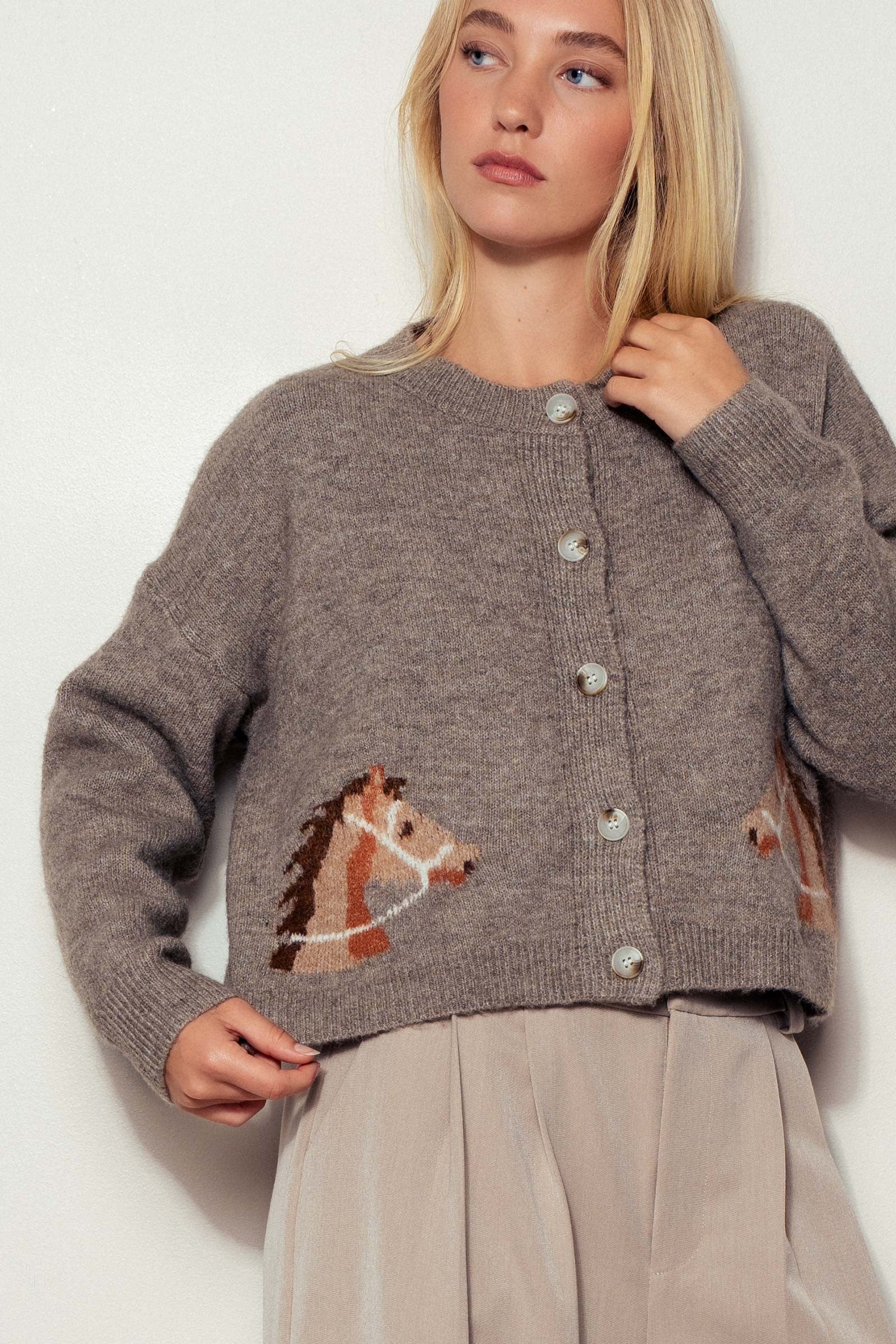 Close-up of Reined In Cardigan highlighting bridled horse head design on soft mocha knit and refined button-up detailing.