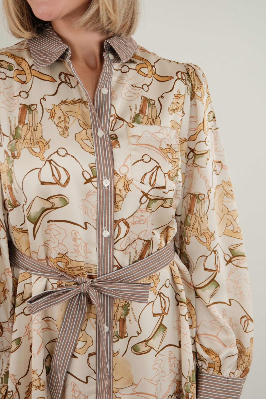 Side profile of ivory Rodeo Rendezvous Mini Dress showing soft tiered ruffle hem, striped cuffs, and flattering belted waist.