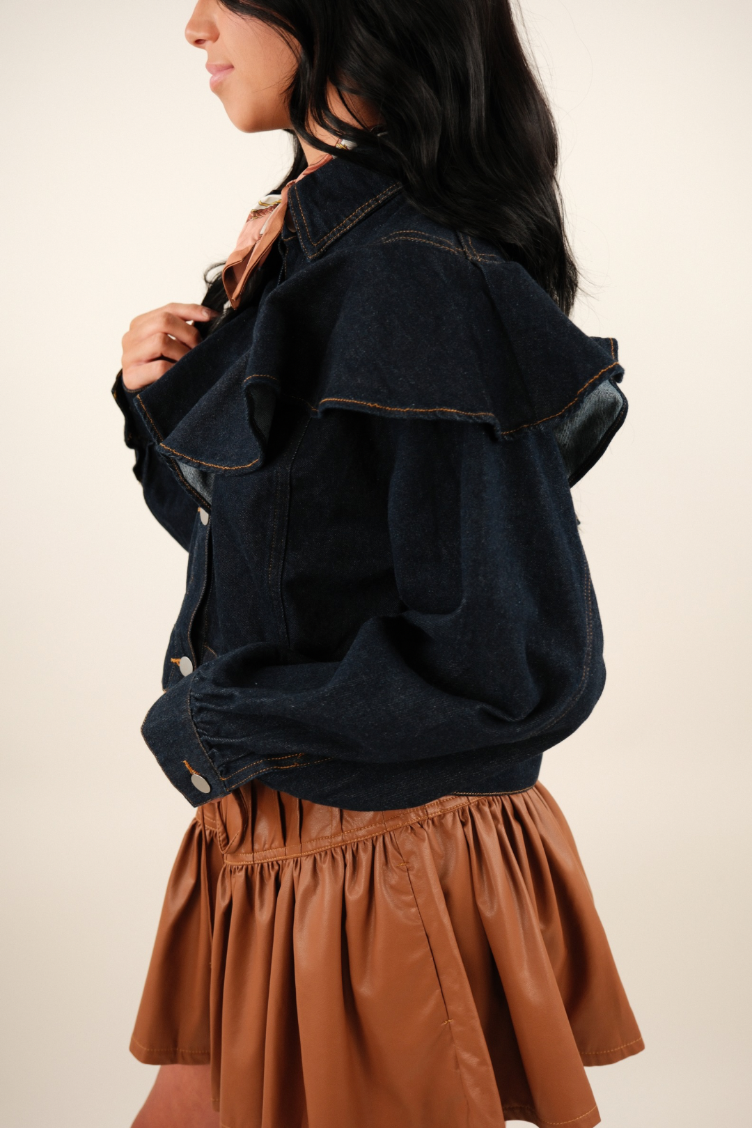 Side profile of Rodeo Ruffle Denim Jacket, women’s cropped western jean jacket with bold ruffle detail on sleeves and side.