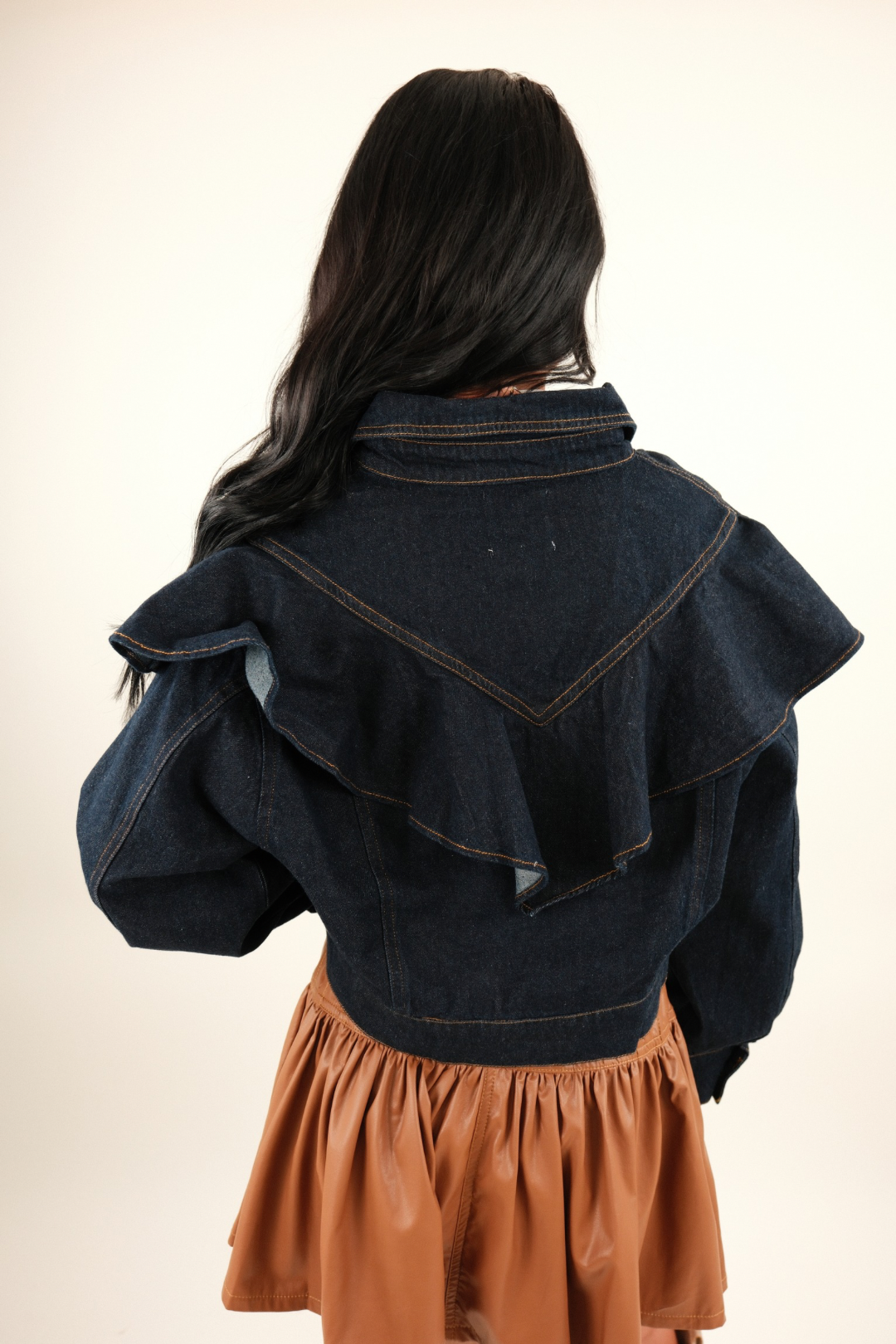 Back view of Rodeo Ruffle Denim Jacket, cropped dark wash women’s western denim jacket with sweeping ruffle across back.