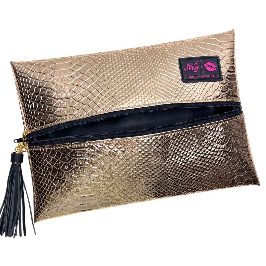 Front view of Rose Gold Python Makeup Junkie bag with rose‑gold python‑print exterior, black zippered front, and matching tassel.