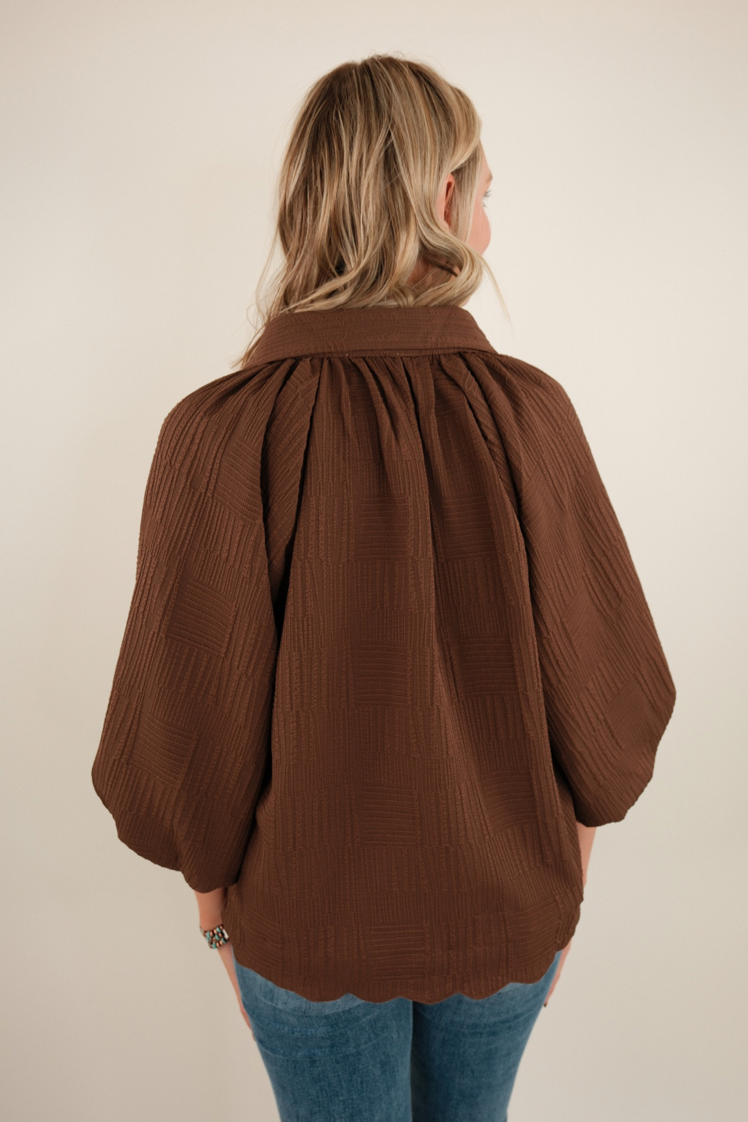 Back view of Saddle Mocha women’s western blouse in chocolate brown, relaxed silhouette with straight hem.
