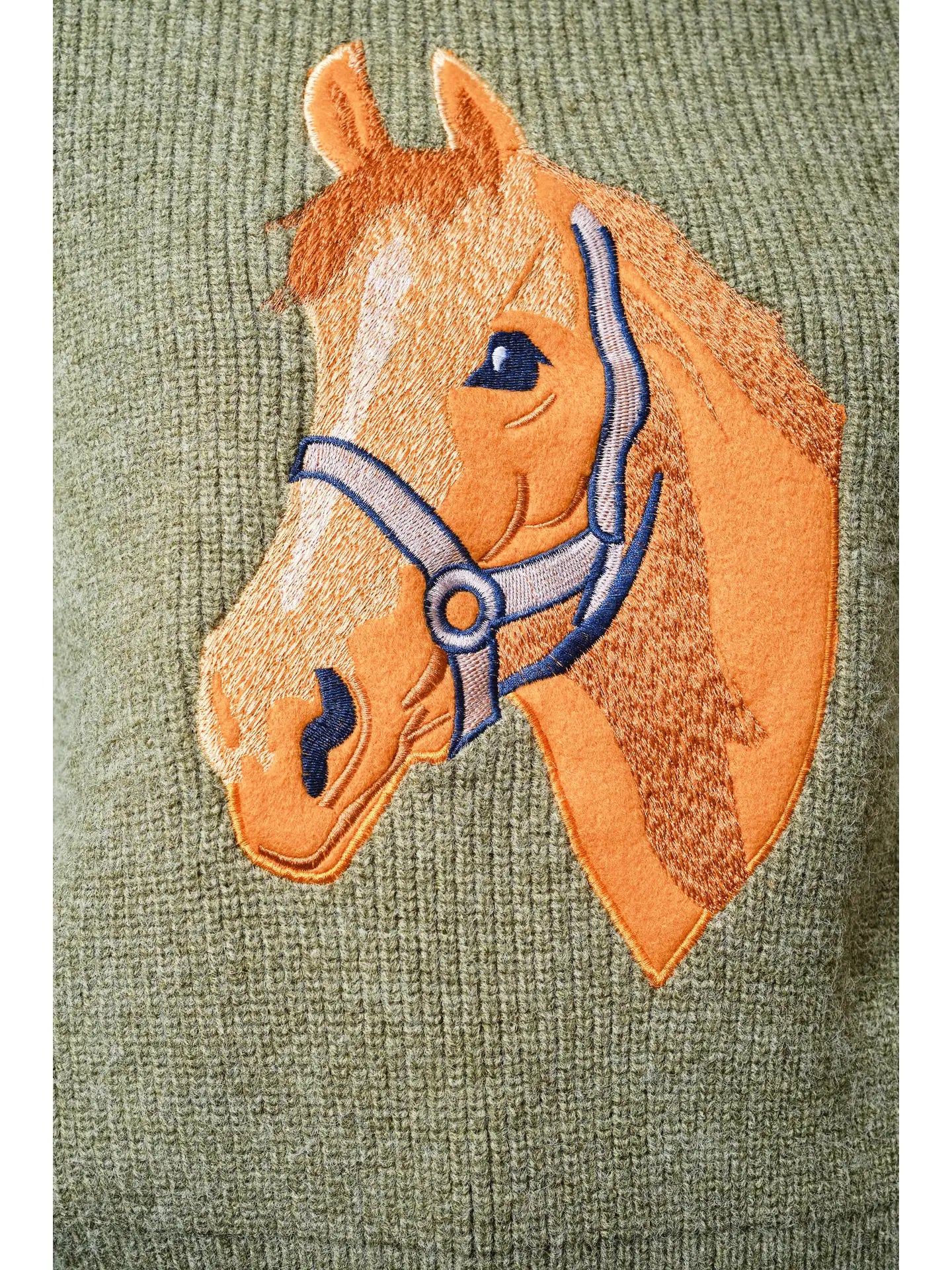 Embroidered horse design on a green sweater background