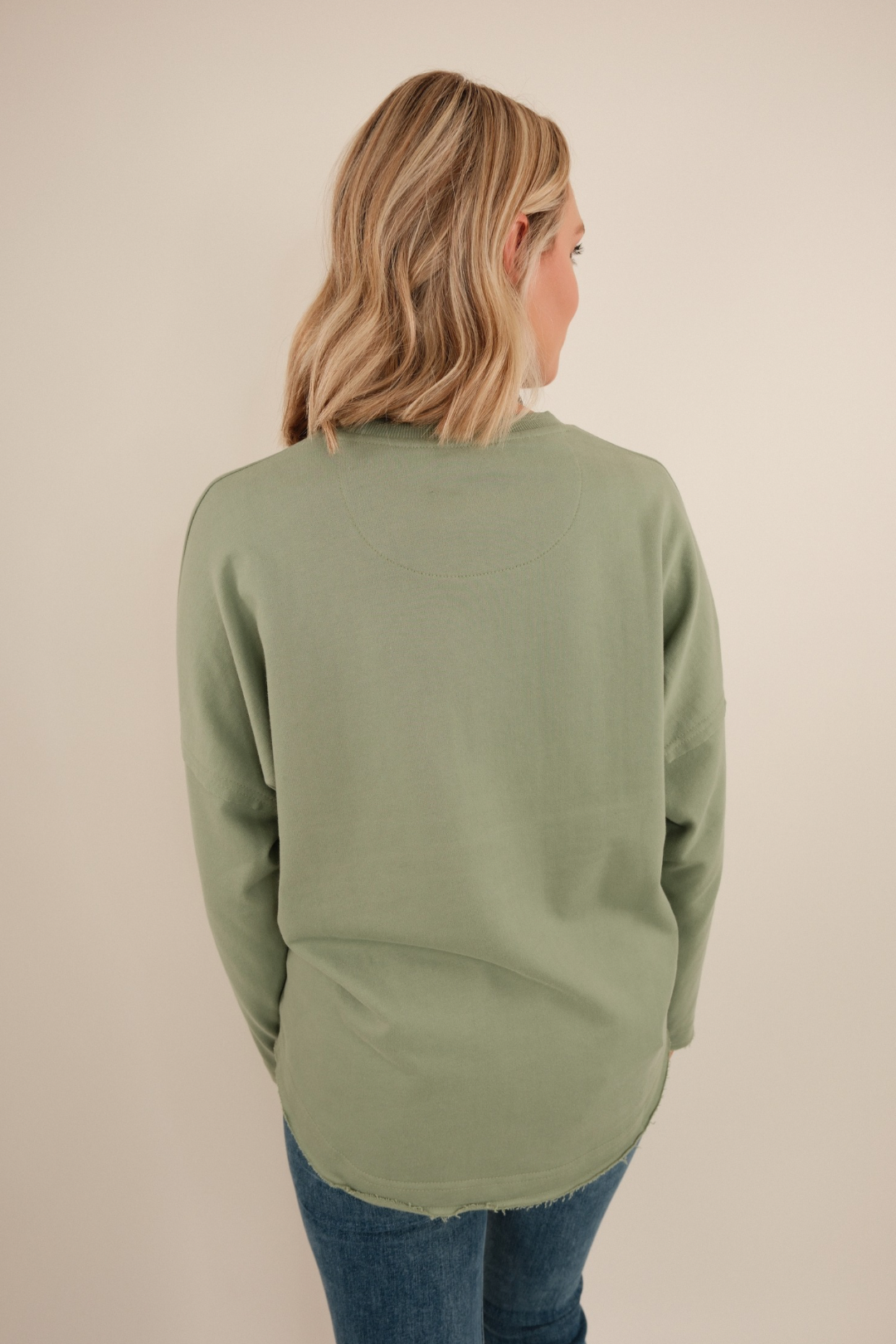 Back view of Sage Haven High Low Terry Top, women’s sage green terry with high-low hemline and relaxed oversized western fit.