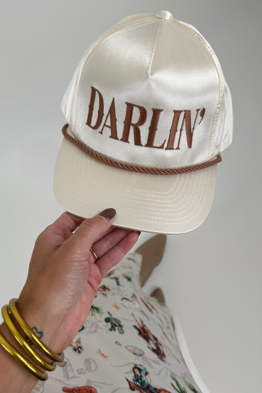 White satin Darlin hat with wide brim and western flair