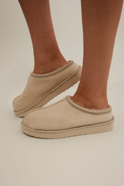Cream faux-leather Sierra Luxe slip-ons with plush fur lining, easy pull-on design, and neutral cowgirl chic style.