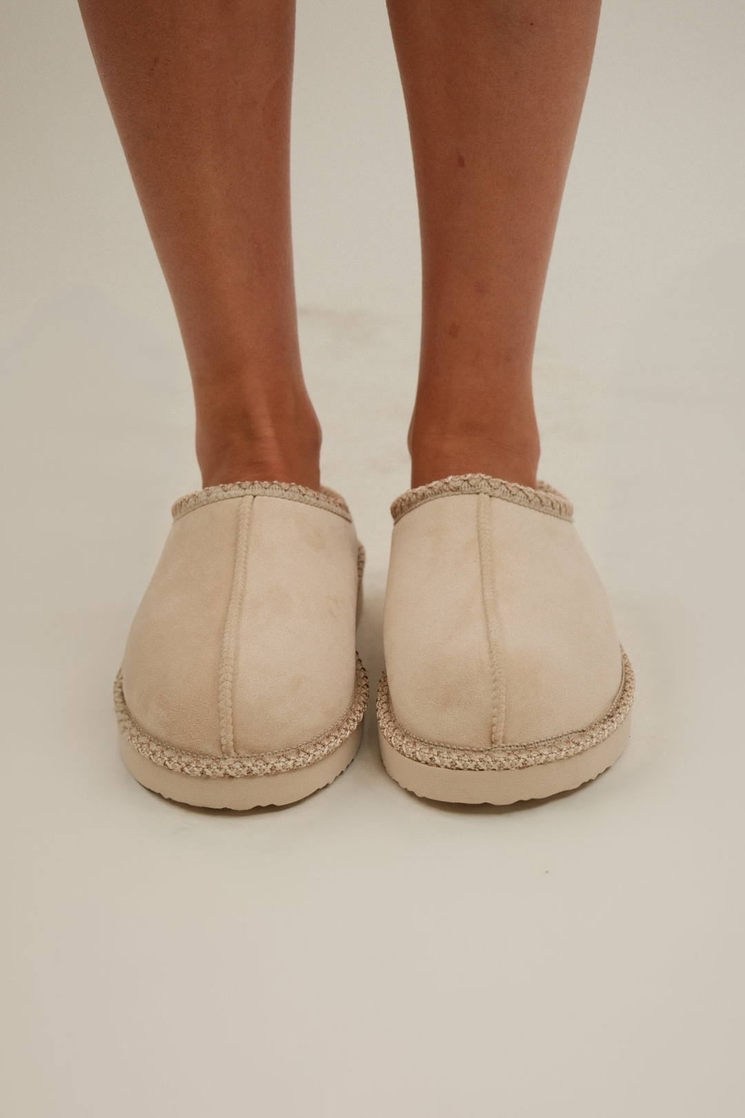 Front view of Sierra Luxe Slip-Ons in cream faux leather with plush fur lining and rounded toe.