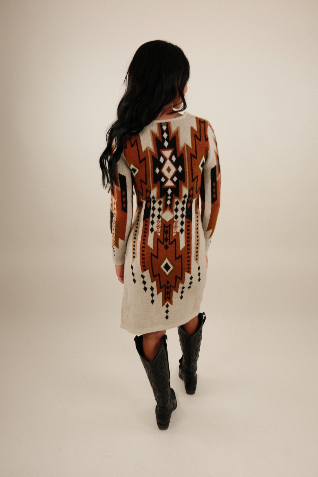 Back view of Sierra Sunset Sweater Dress in ivory knit with ribbed cuffs and straight silhouette.