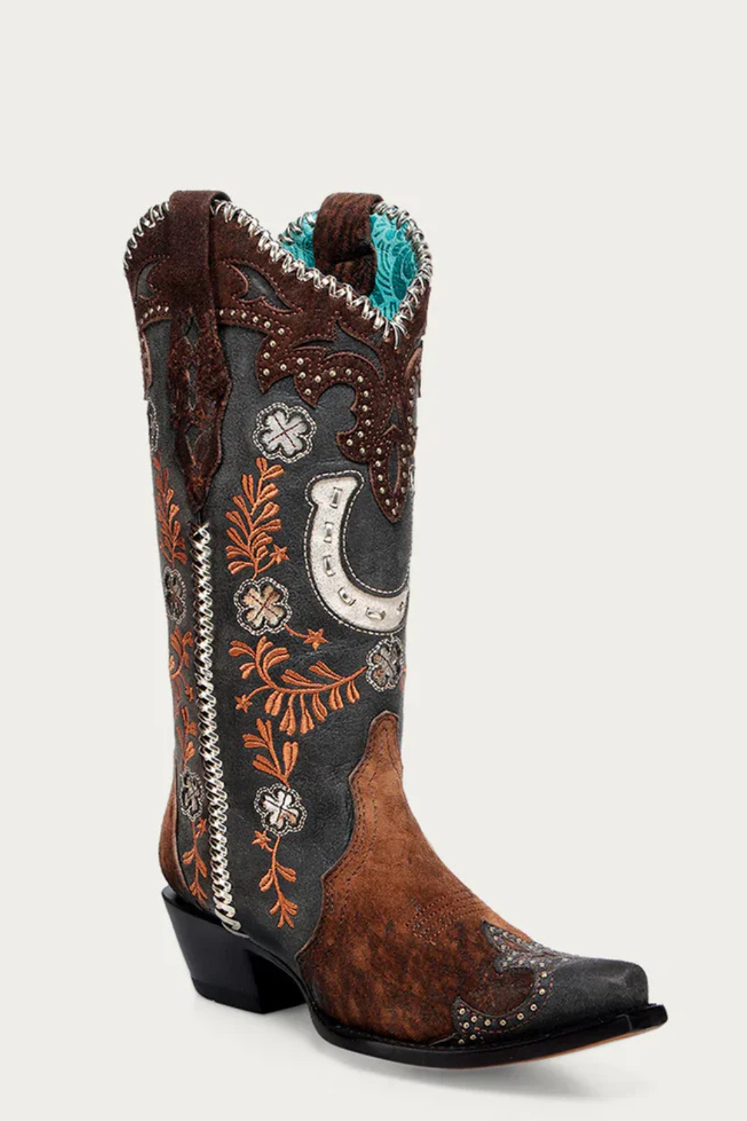 Decorative cowboy boot with intricate patterns on a white background