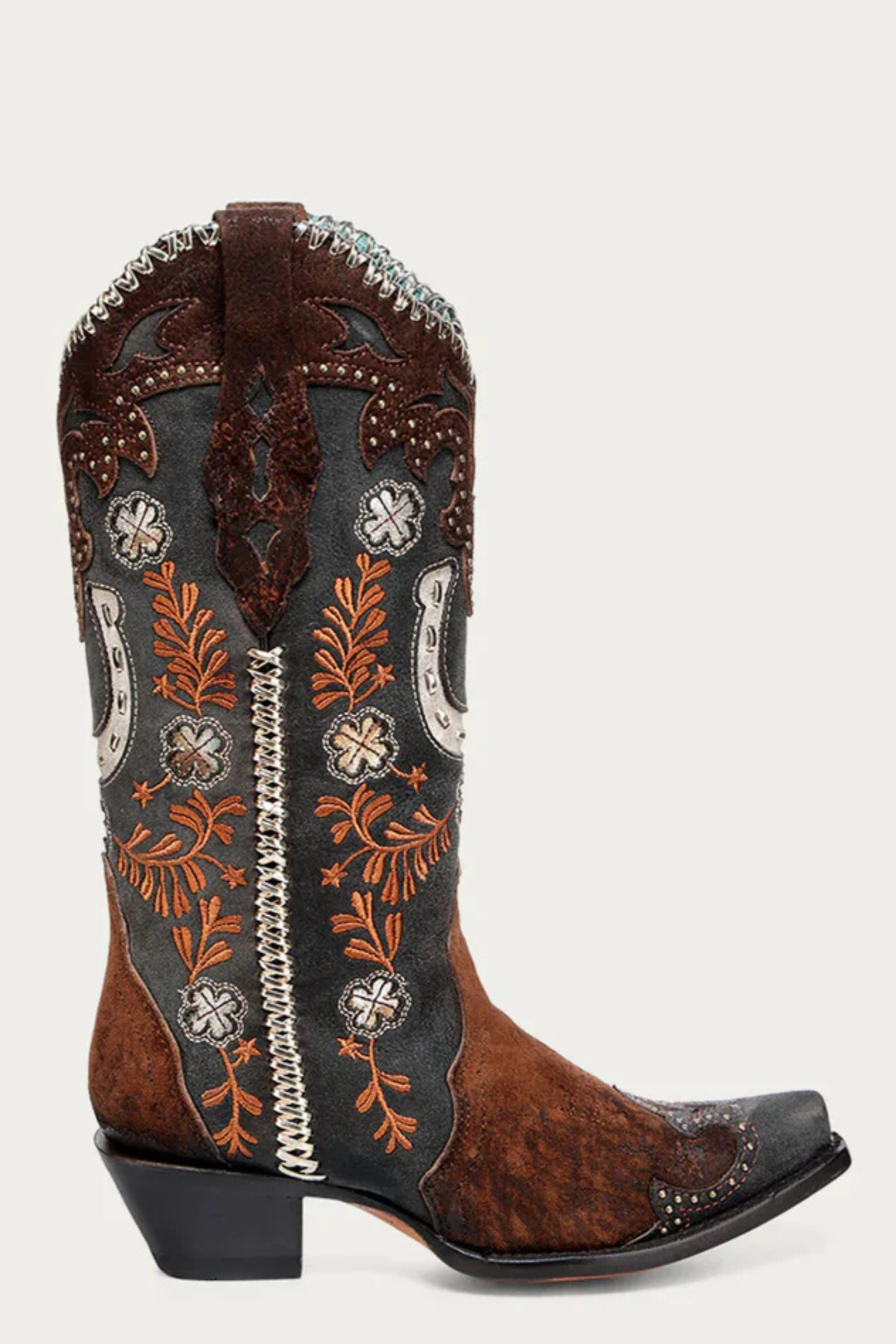 Decorative cowboy boot with intricate patterns on a white background