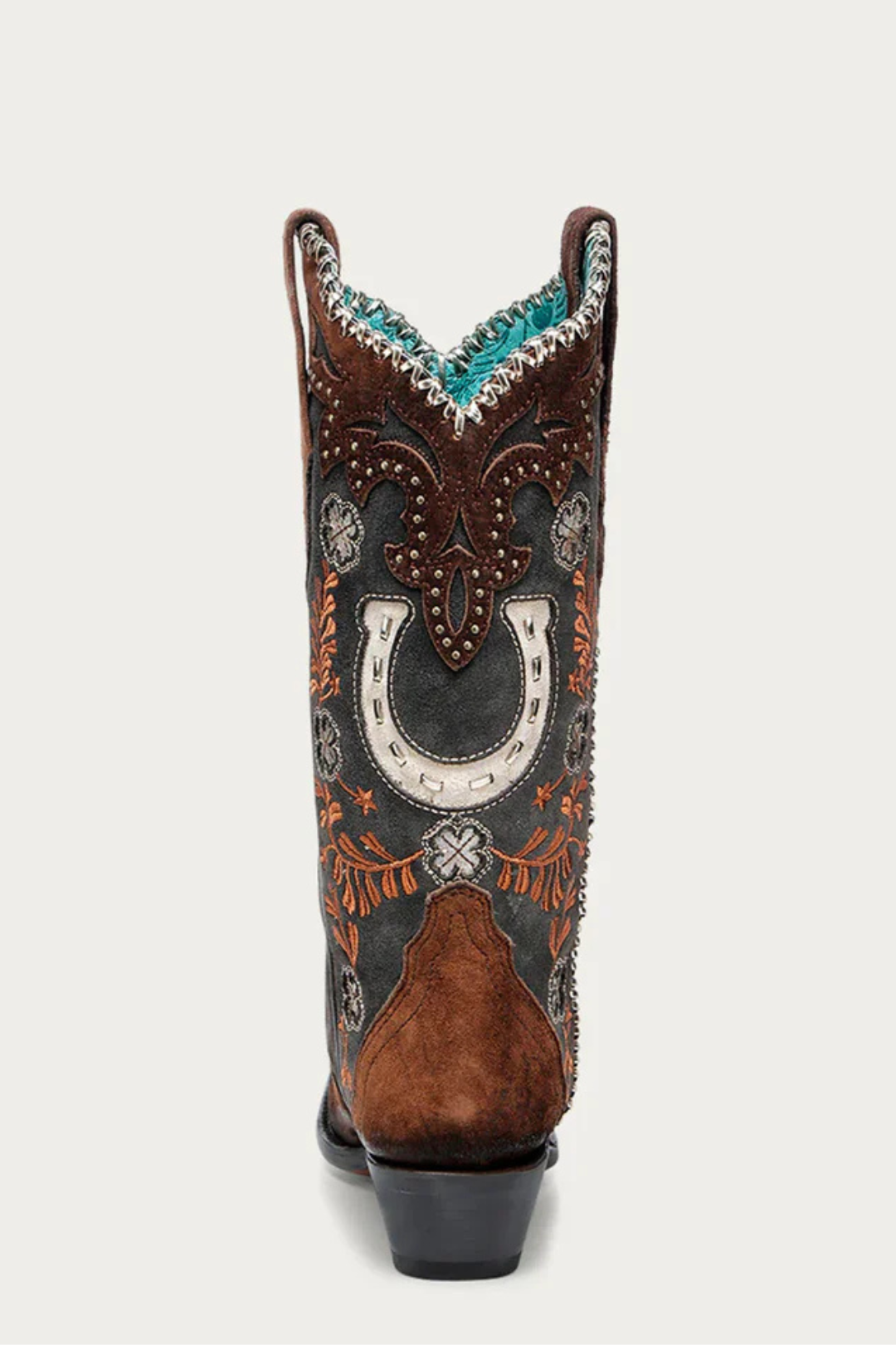 Decorative cowboy boot with intricate patterns on a white background