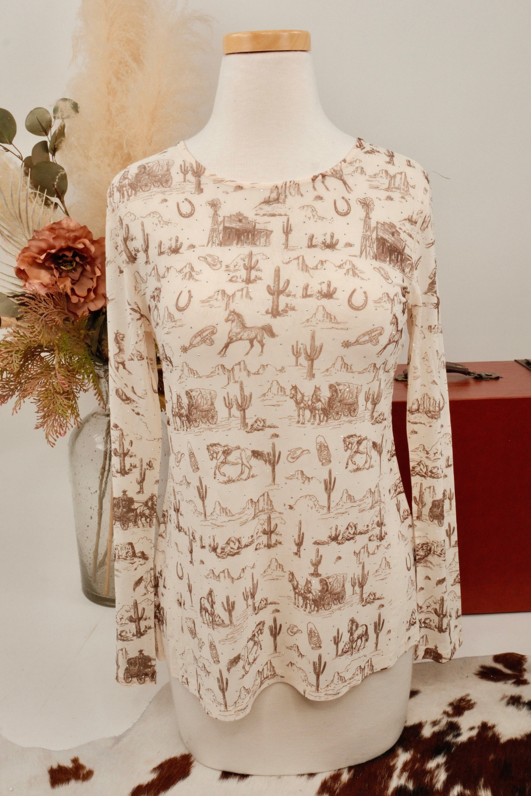 Long-sleeve mesh shirt with nature-themed print on a mannequin against a neutral background