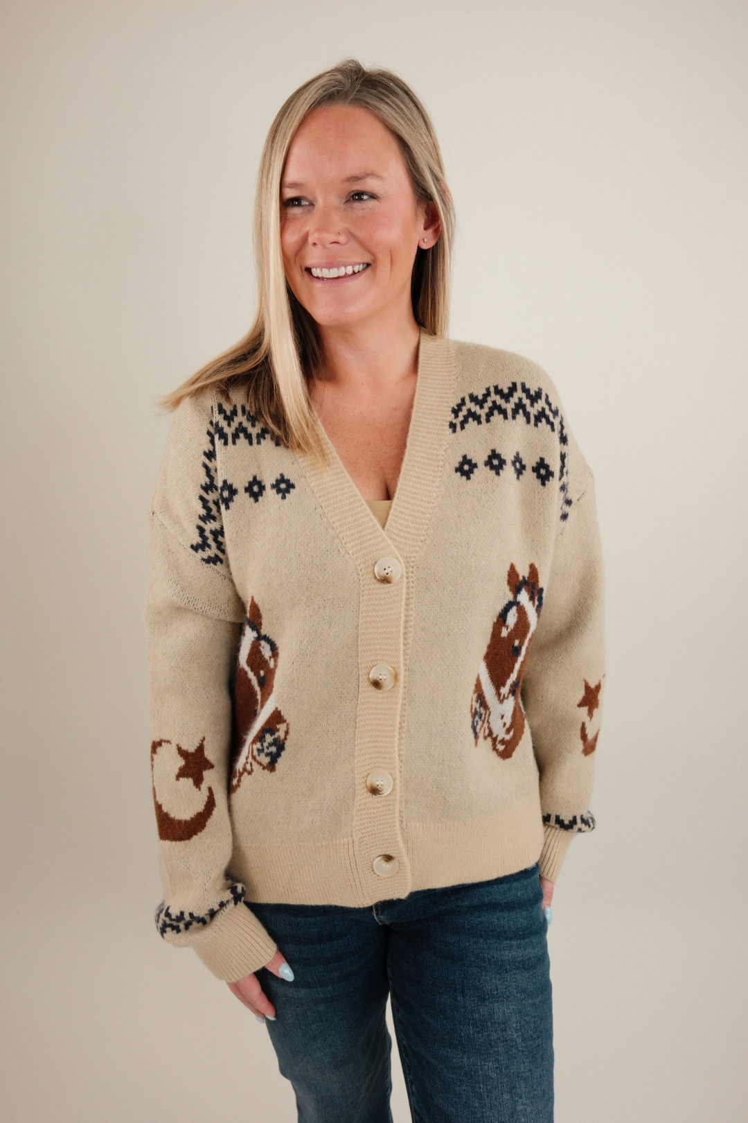 Beige knit Starlight Mustang cardigan with horse motifs, button-front, western style layering piece.