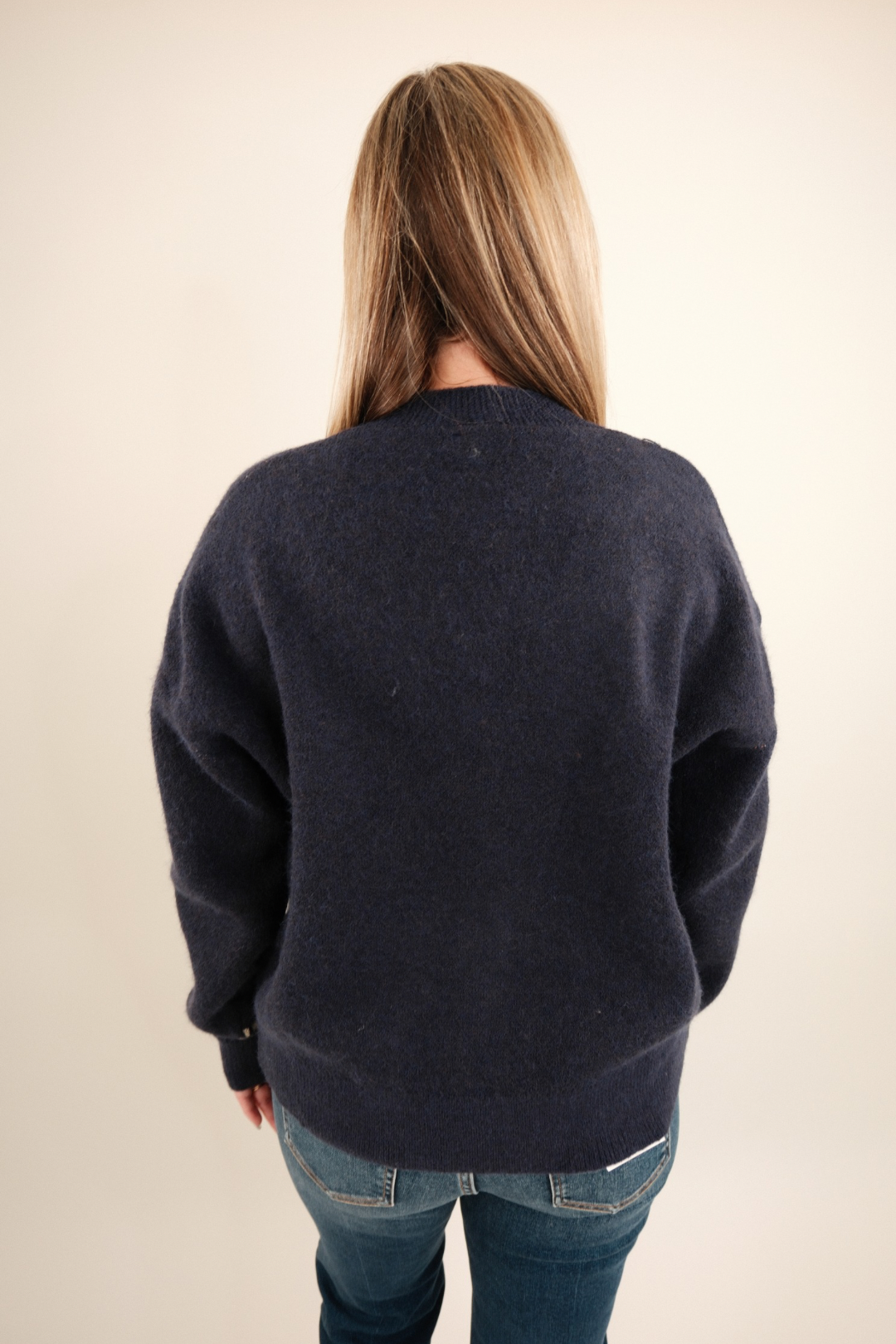 Back view of Starlight Mustang Cardigan, women’s navy knit cowgirl cardigan with bold galloping horse design.