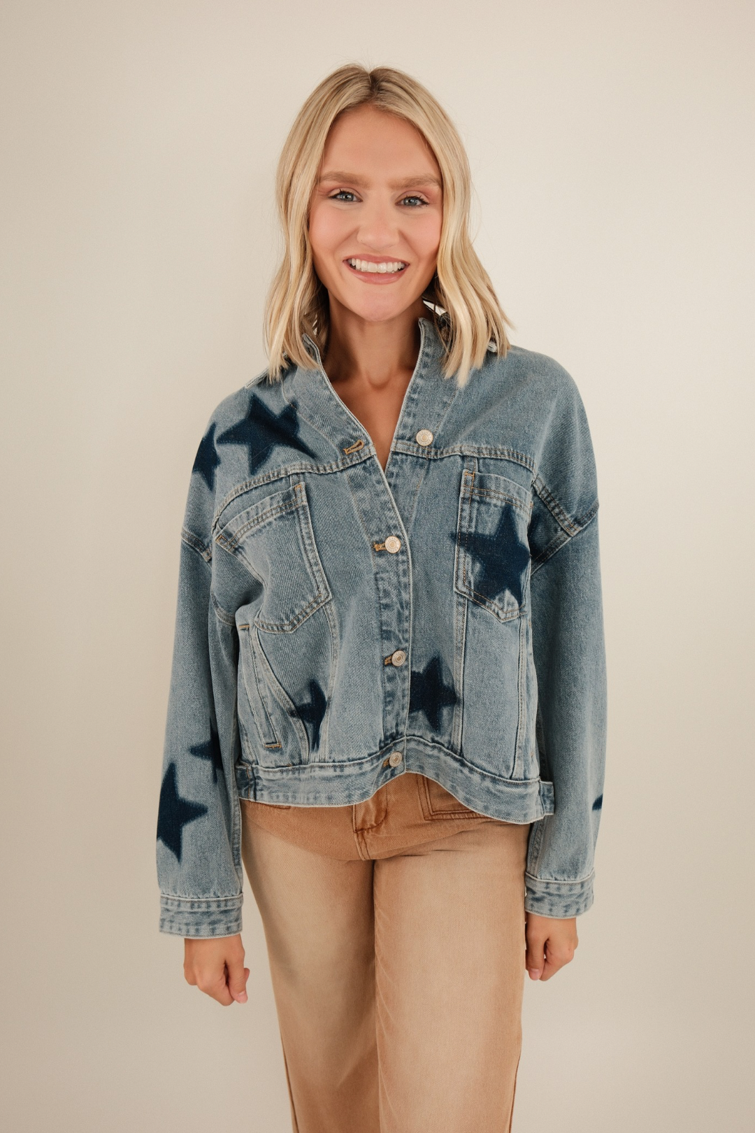 Front view of Starlit Range Denim Jacket in mineral medium wash with bold dark denim star patches and boxy western fit.