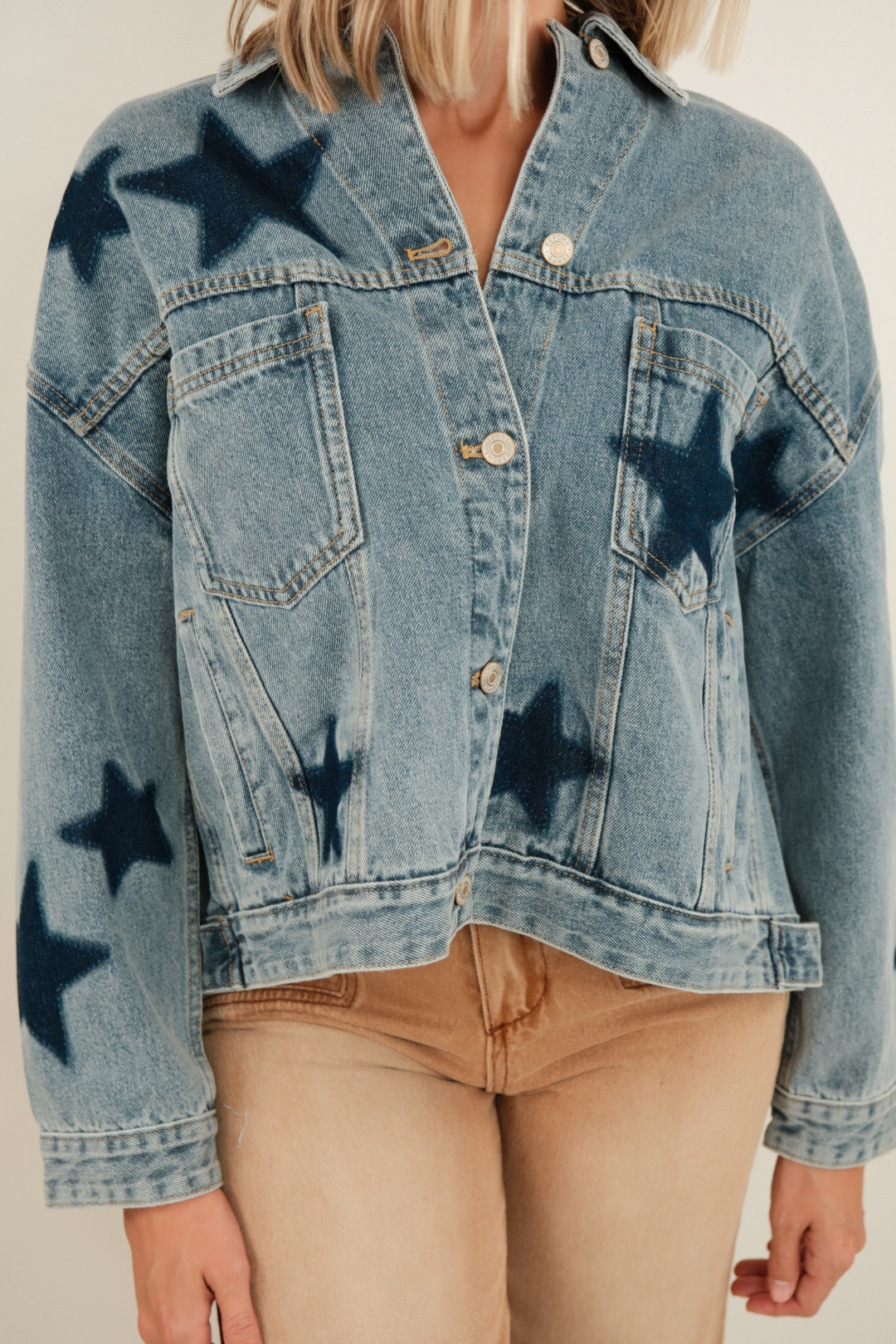 Close-up of Starlit Range Denim Jacket highlighting mineral medium wash denim, contrast star patches and sturdy button detail.