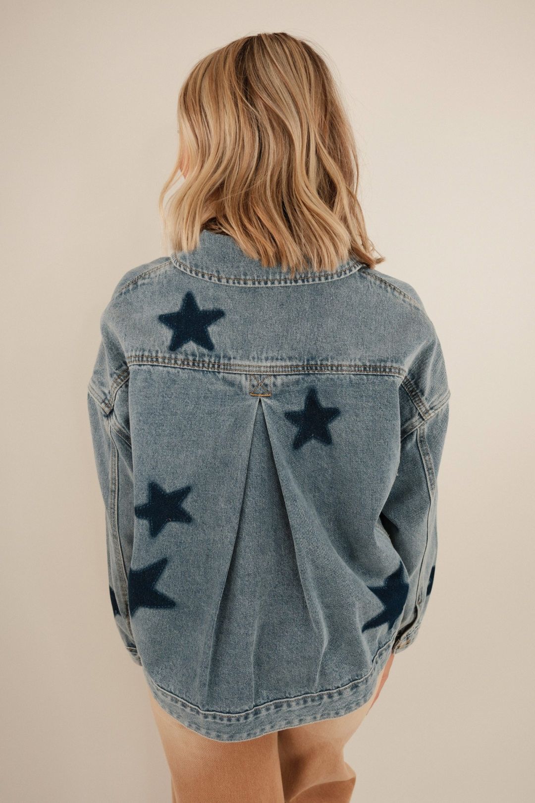 Back view of Starlit Range Denim Jacket featuring dark denim star patches on mineral wash with classic western yoke seam.