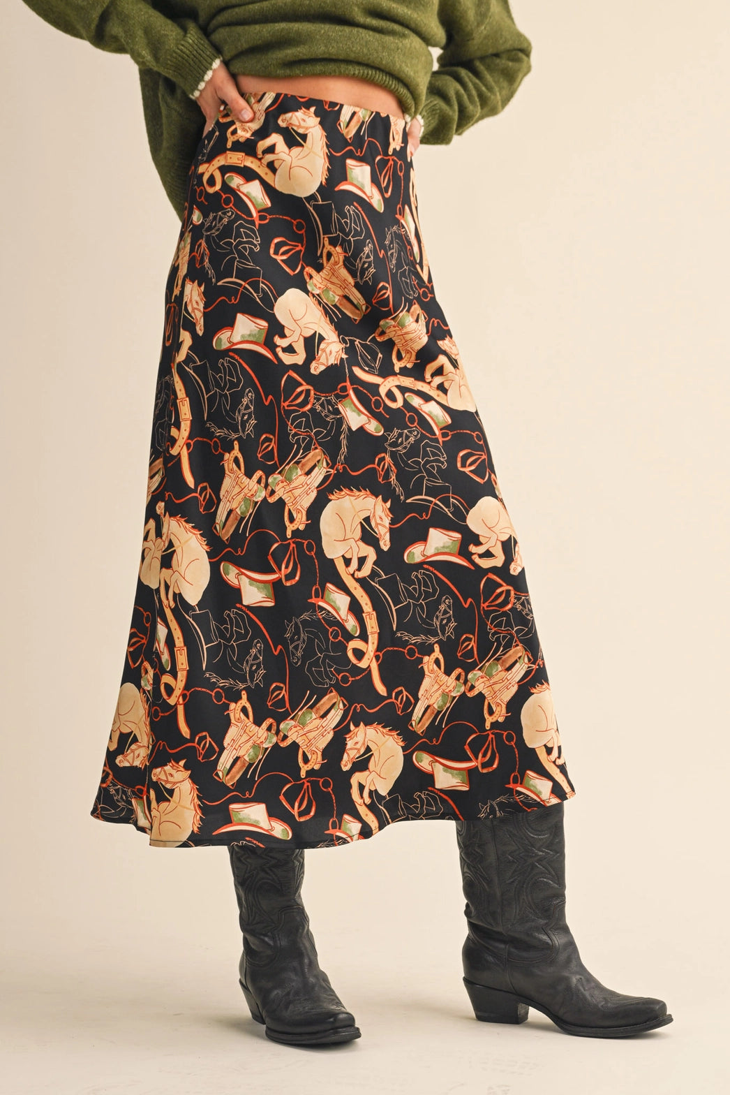 Front view of Stirrup Stories Satin Midi Skirt, high-waisted satin slip skirt with equestrian print of horses, bridles, and bits.