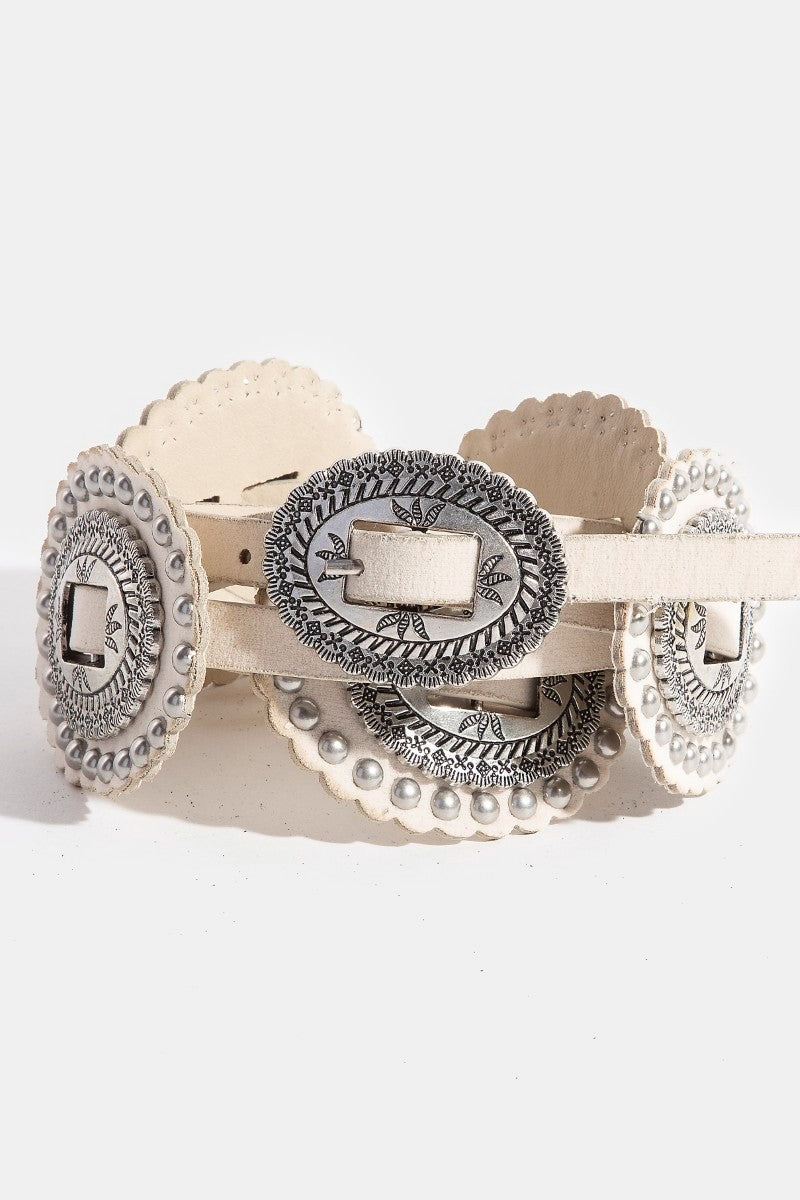 Belt with decorative beige conchos and silver accents on a white background