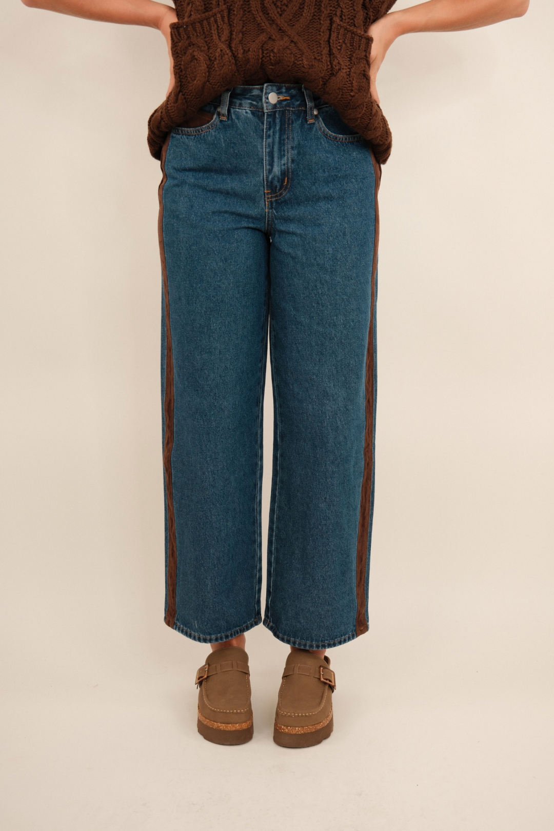 Front view of Sundance straight leg denim jeans in mid-wash blue with high waist and clean silhouette.