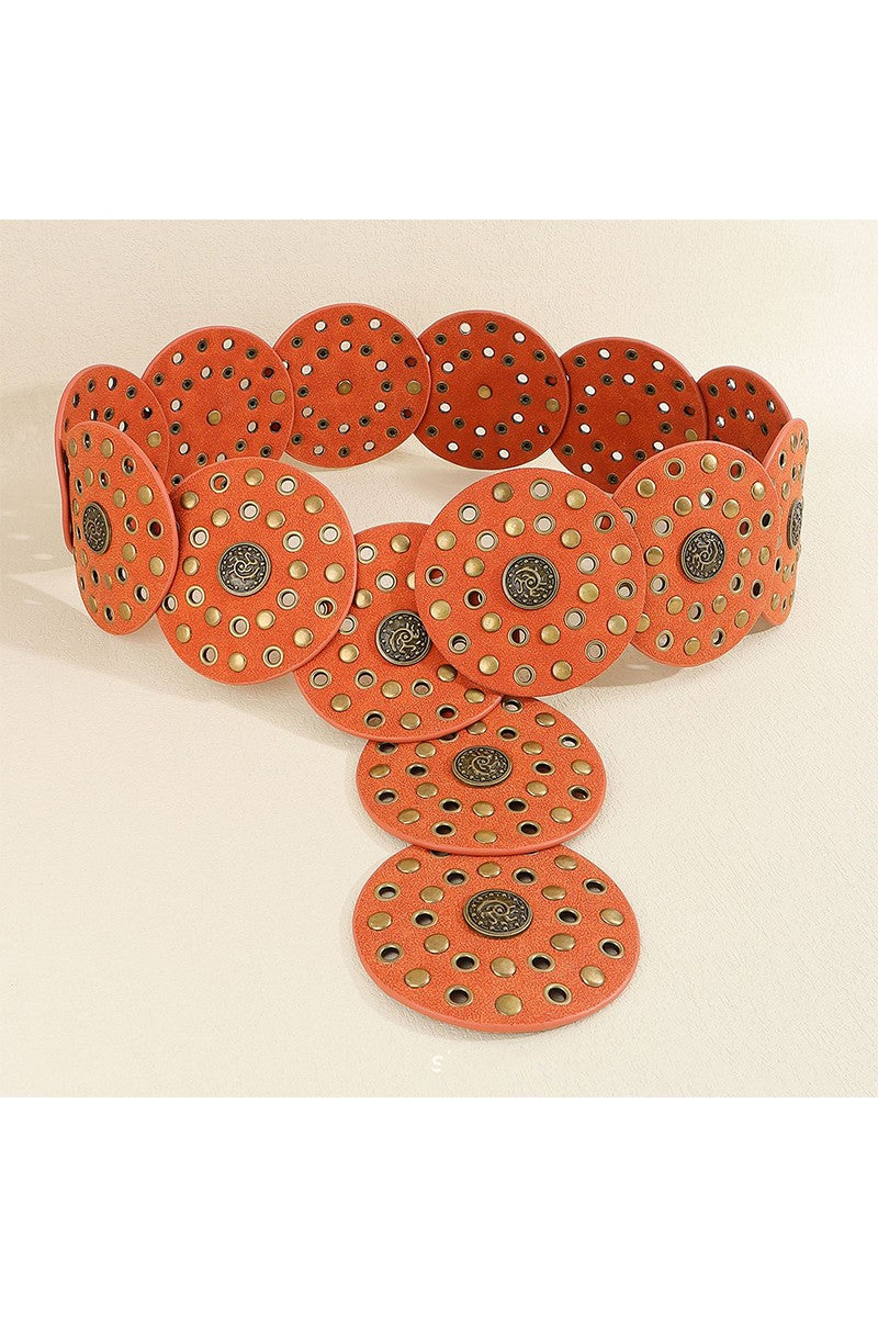 Cognac belt with circular patterns and metallic accents on a beige background