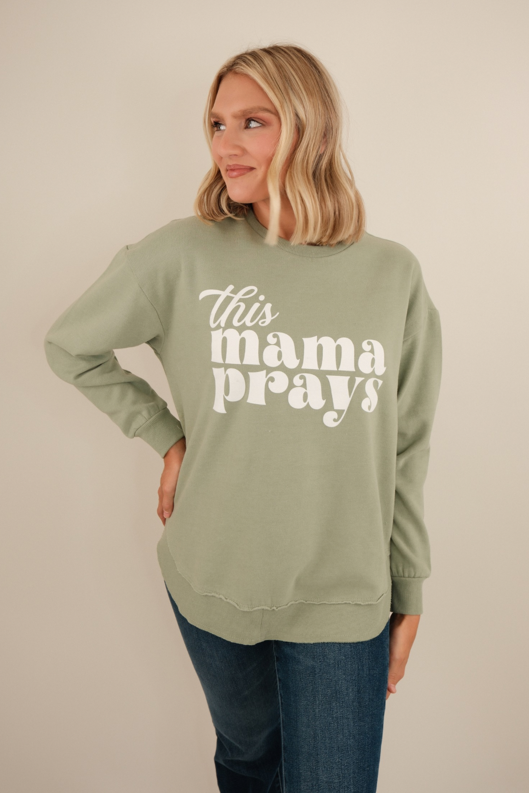 Sage knit poncho fleece with “This Mama Prays” text — relaxed fit, rounded hem, cozy western layering piece.