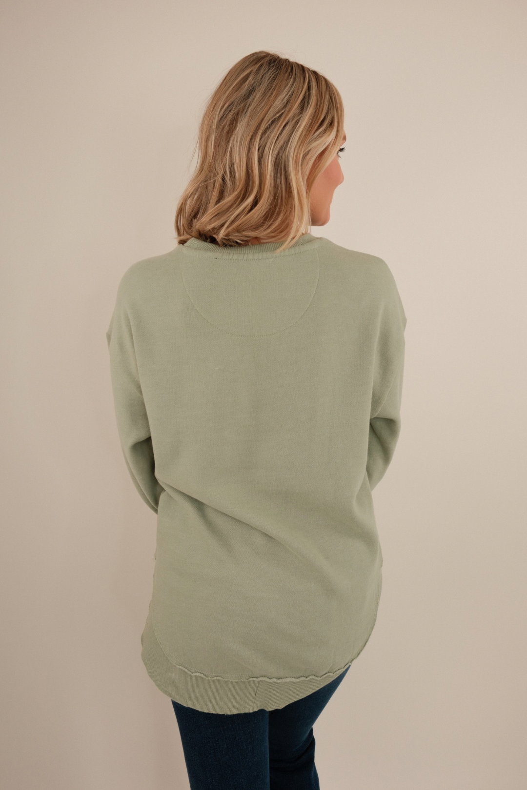 Back view of This Mama Prays Poncho Fleece in sage knit with clean back, poncho drape and western-inspired silhouette.