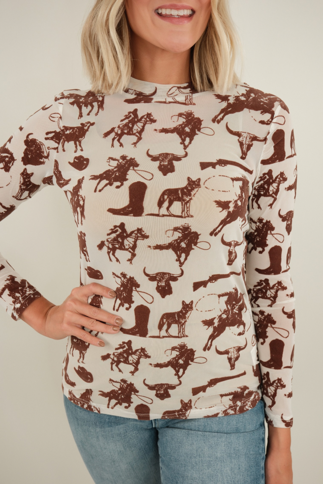 Close-up of Velvet Frontier Mesh Top highlighting cream mesh texture and brown velvet cowboy and buffalo motifs.