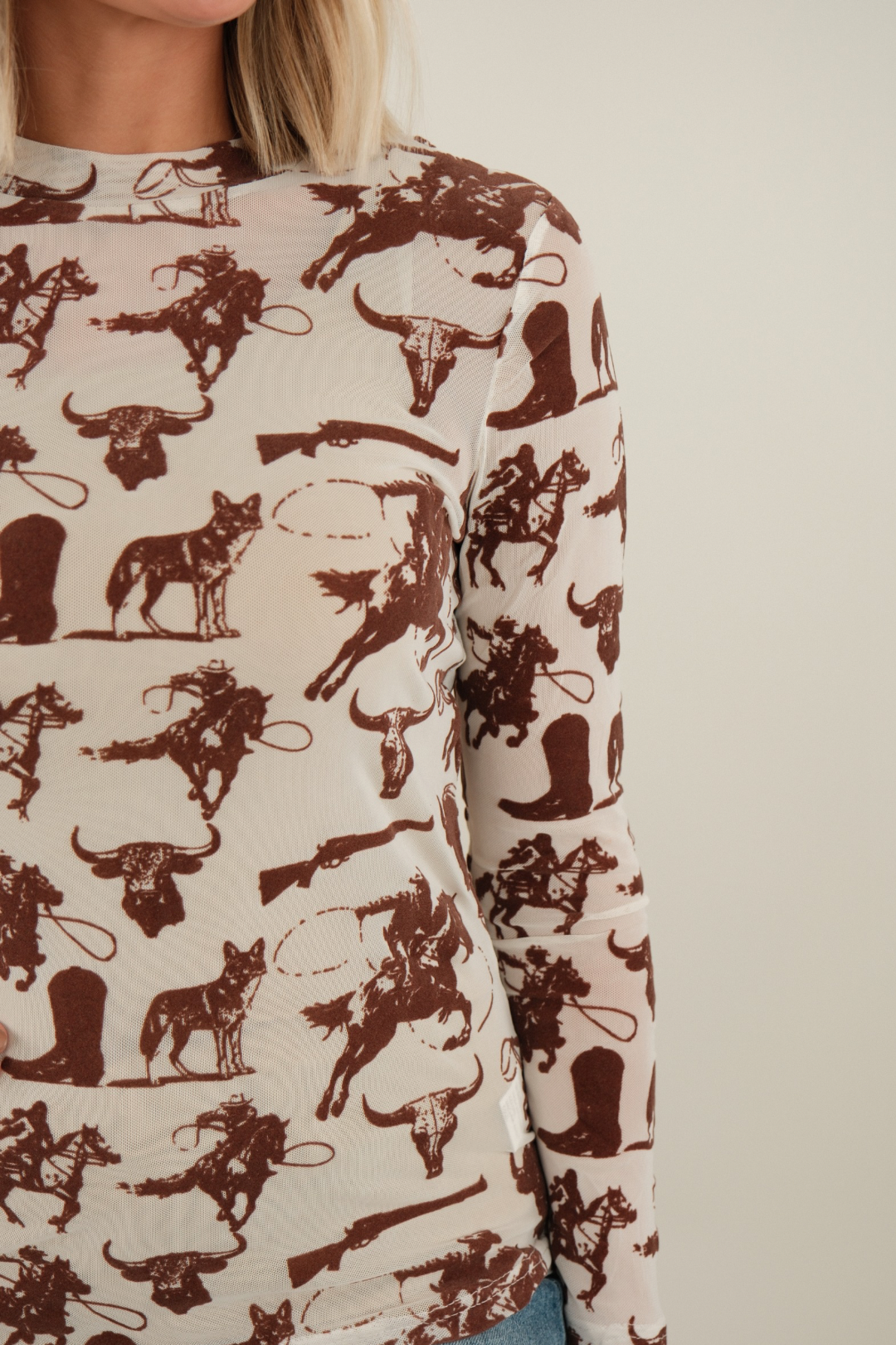 Side profile of Velvet Frontier Mesh Top showing sheer cream sleeve with brown velvet western design.
