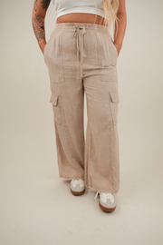 Front view of Wanderlight cargo pants in washed mauve linen blend with elastic waist, drawstring, and side slit cargo pockets.