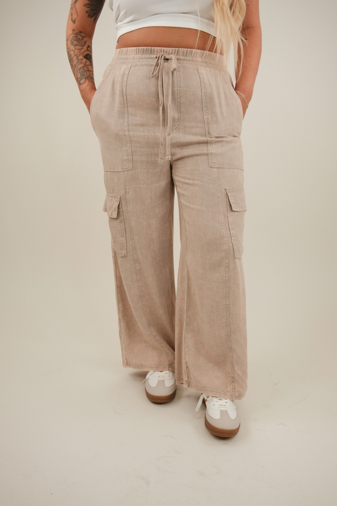 Front view of Wanderlight cargo pants in washed mauve linen blend with elastic waist, drawstring, and side slit cargo pockets.