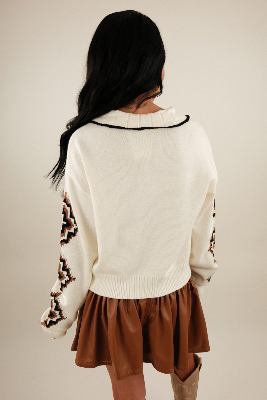 Back view of Western Belle Cardigan showing ivory knit design with horse head and Aztec sleeve pattern.