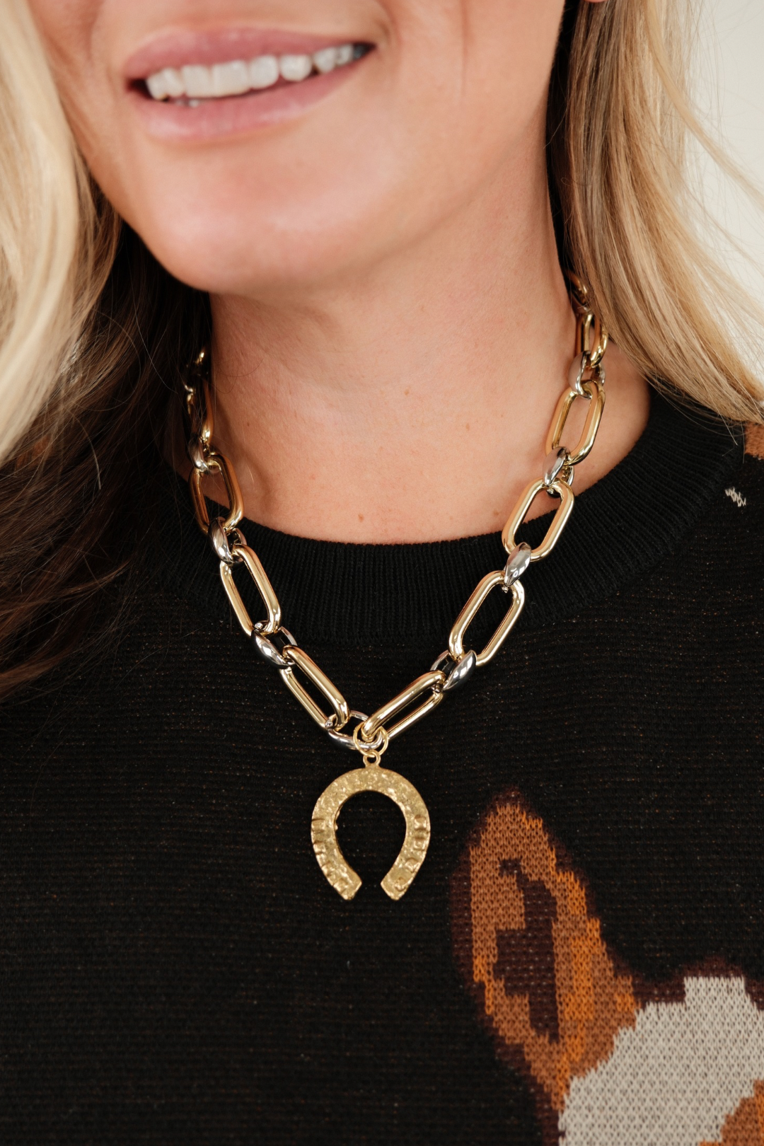 Front view of Western Luck Mixed Metal Necklace with interlocking silver and gold links and rustic gold horseshoe pendant for western charm.