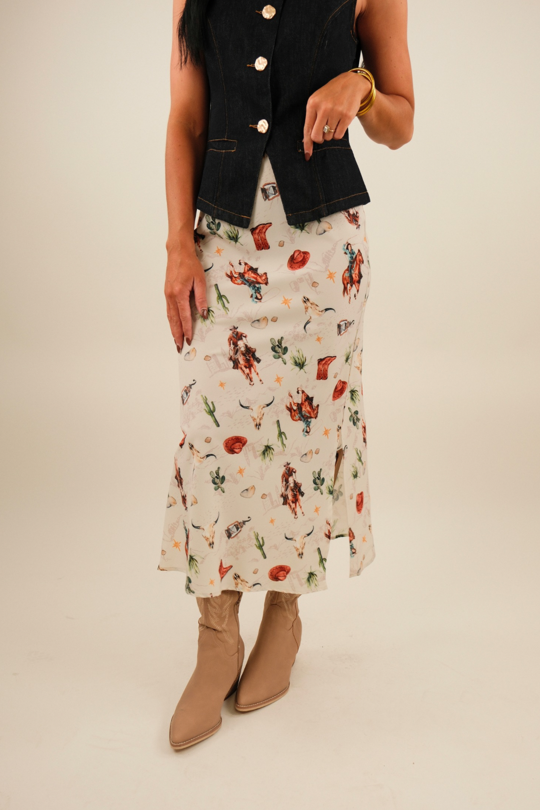 Front view of Western Muse Skirt in cream with galloping horses, cacti, bull skulls and cowboy hat motifs, straight fit with side slits.