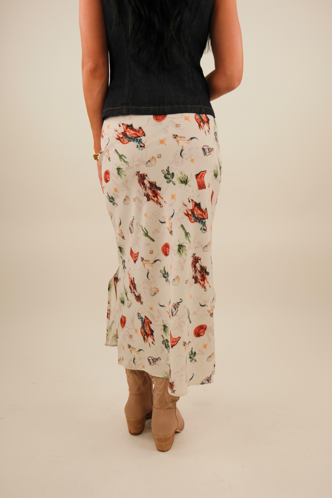 Back view of Western Muse Skirt in cream patterned with horses, cacti, bull skulls and cowboy hats, straight western-inspired fit.