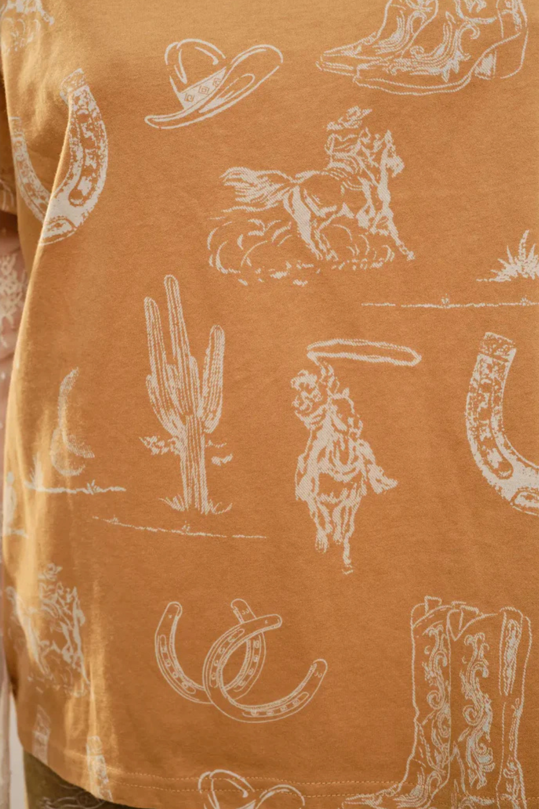 Patterned fabric with cowboy-themed designs on a camel background