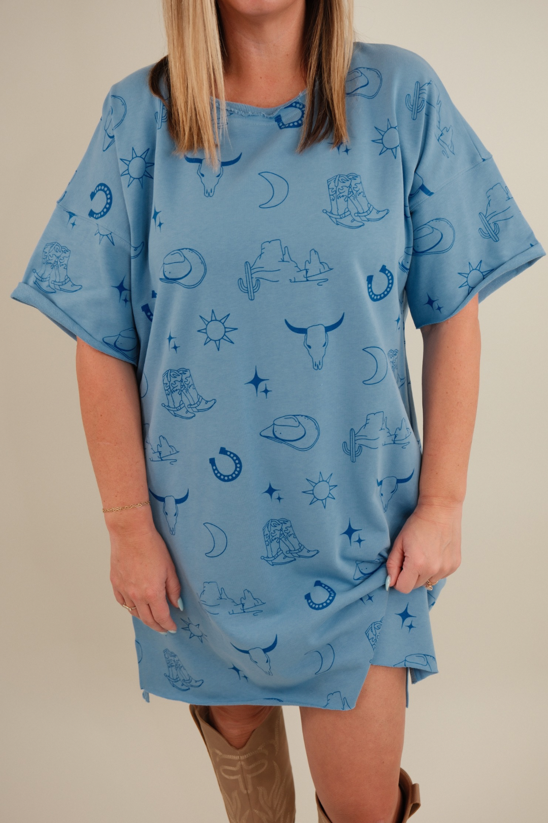 Close-up of Western Skies Tee Dress showing light blue cotton fabric, crew neckline, and western-inspired casual style.