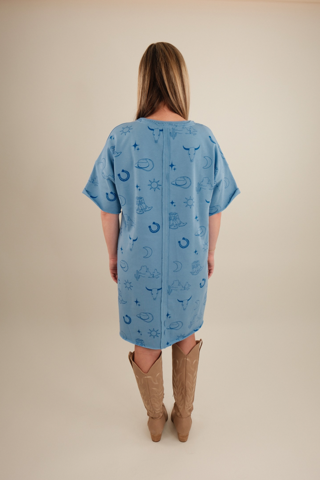 Back view of Western Skies Tee Dress, women’s light blue short sleeve cowgirl t-shirt dress with relaxed fit.