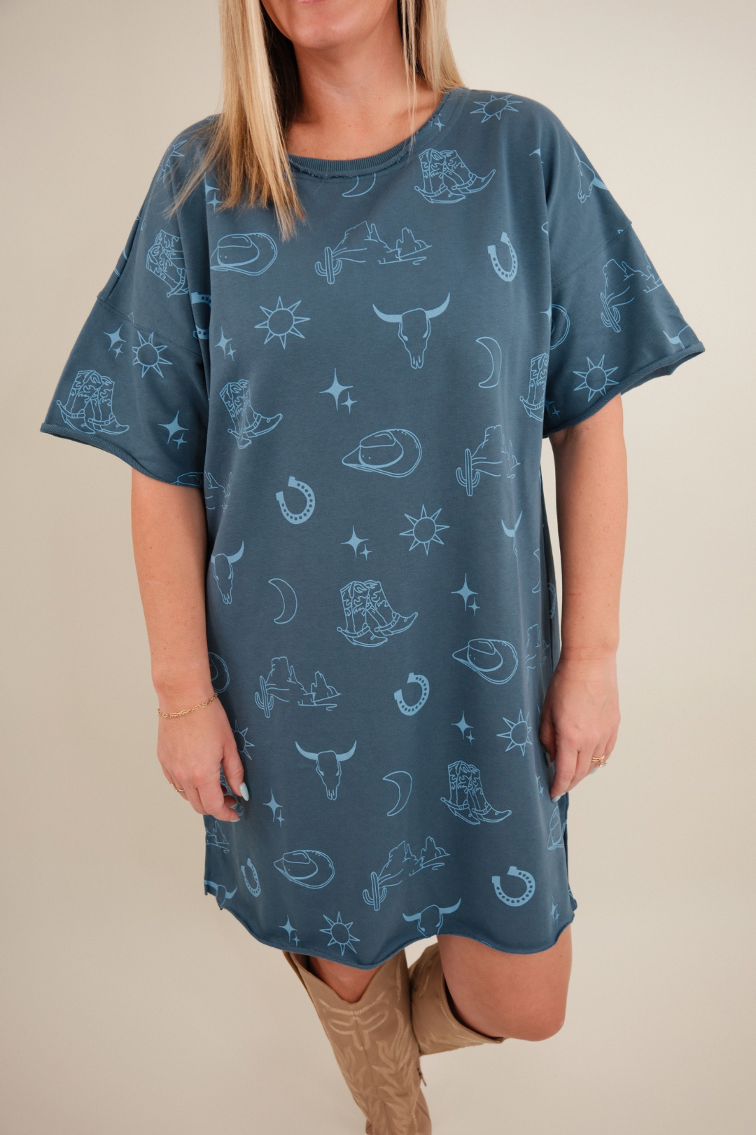 Close-up of Western Skies Tee Dress showing dusty blue cotton fabric, crew neckline, and western-inspired casual style.