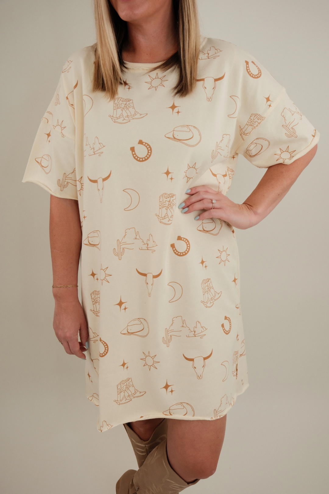 Close-up of Western Skies Tee Dress showing cream cotton fabric, crew neckline, and western-inspired casual style.