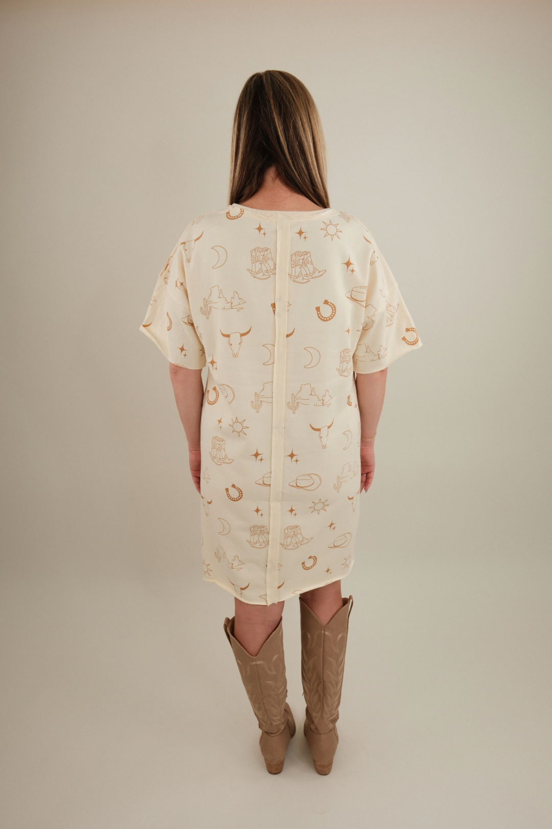 Back view of Western Skies Tee Dress, women’s cream short sleeve cowgirl t-shirt dress with relaxed fit.
