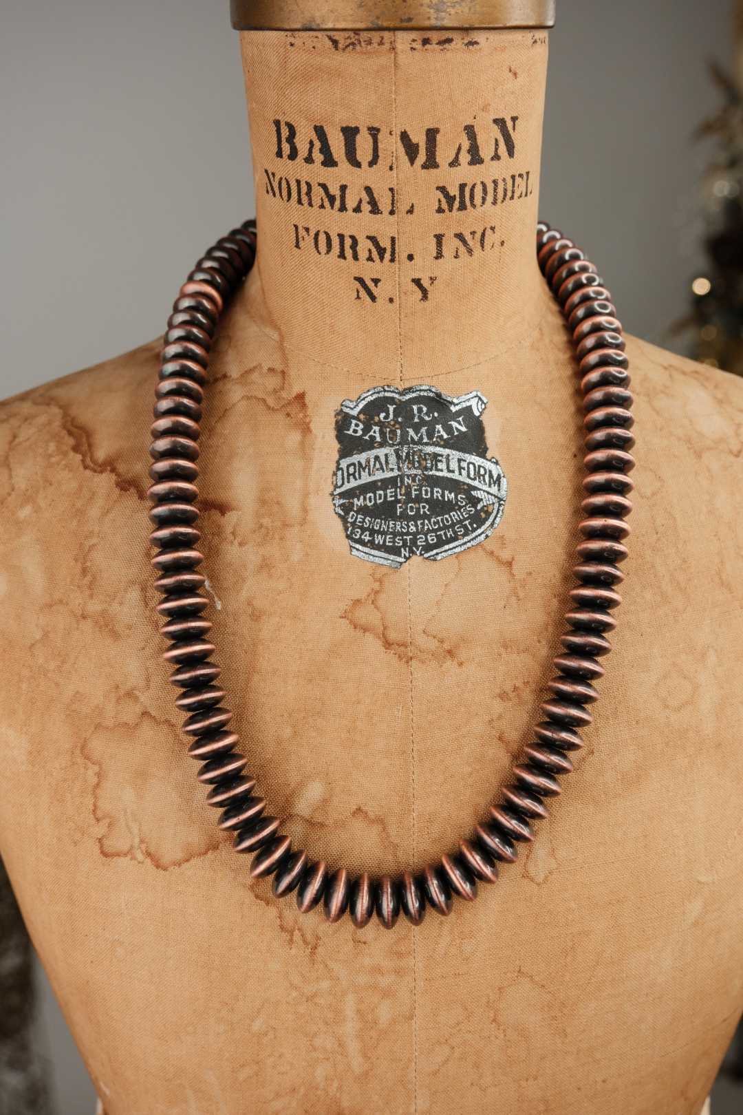 Chunky navajo pearl necklace on a mannequin with 'Bauman Normal Model Form, Inc.' branding.