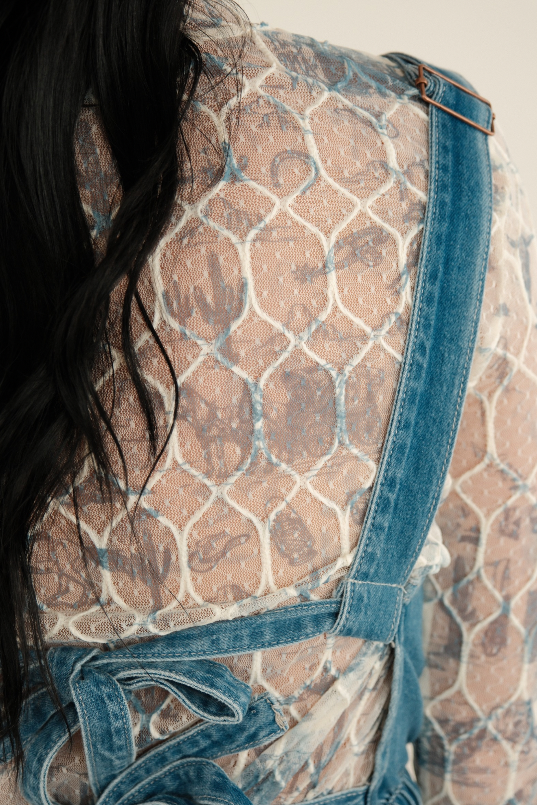 Side or back view showing the continuation of the whimsical western print across sleeves and upper back, highlighting the mesh’s drape. Mesh Top 