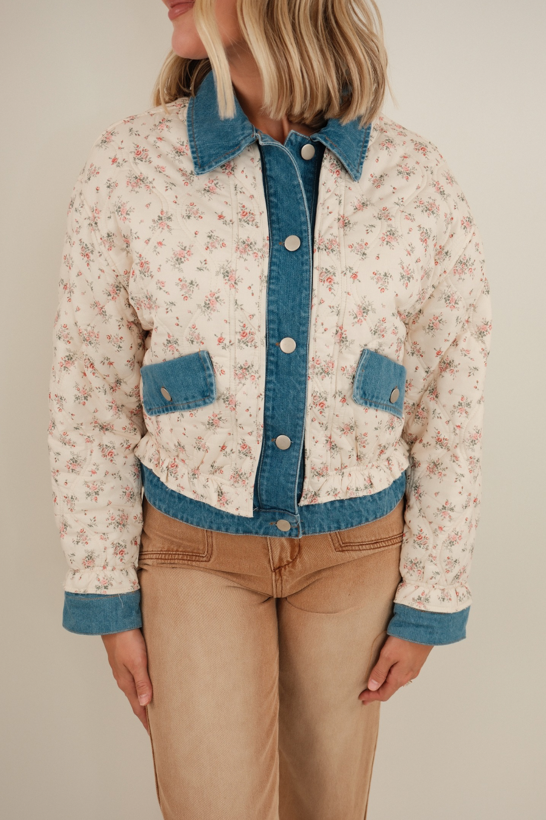 Women’s Wildflower Quilted Denim Jacket in medium wash with floral quilted overlay, button-front western style and ruffle collar detail.