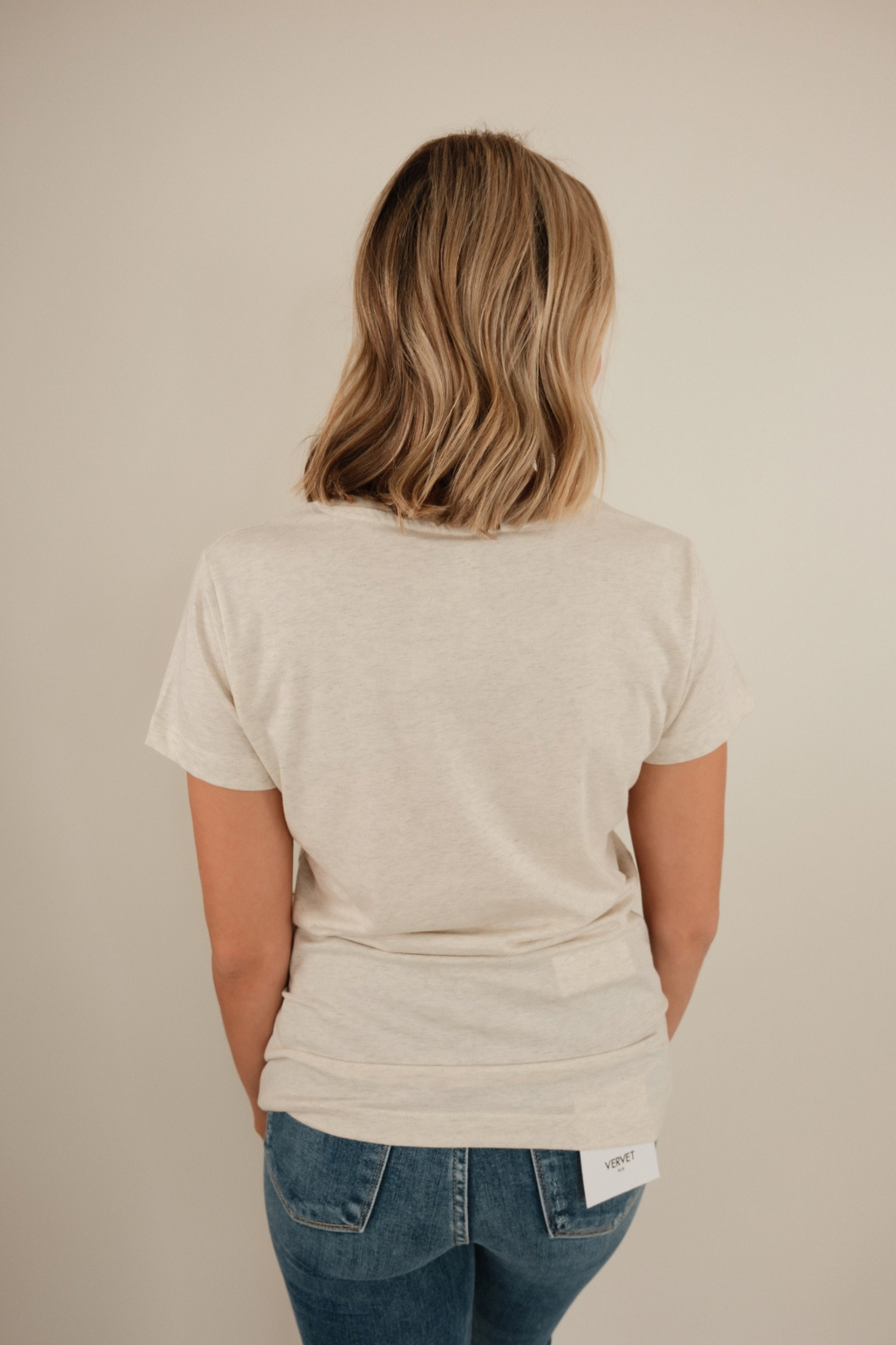Back view of Yeehaw Studded Tee in oatmeal with plain back and relaxed western-inspired silhouette.